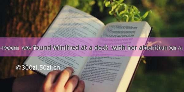 In the reading-room  we found Winifred at a desk  with her attention on a novelA. sitting